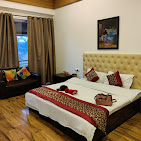 Skye Meadows guest room with wooden floor and bed